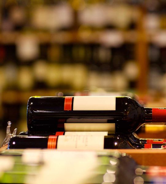A shot of wine bottle in wine section of supermarket